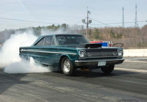 Plymouth burn out at a drag racing track.