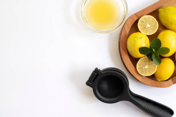 istock Lemon juicer, lemon juice and lemons on a white background 1442299888
