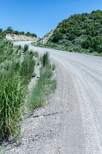 Winding dirt and gravel country road high up in the Wasatch Mountains Range in Utah, in the western United States of America.
