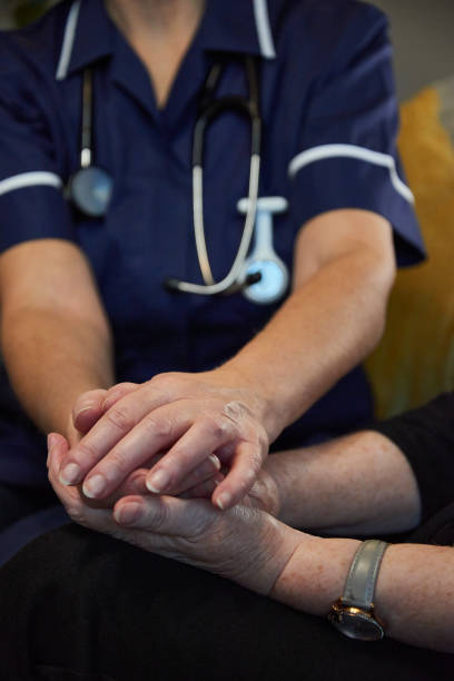 istock Nurse comforting senior patient 1442301292