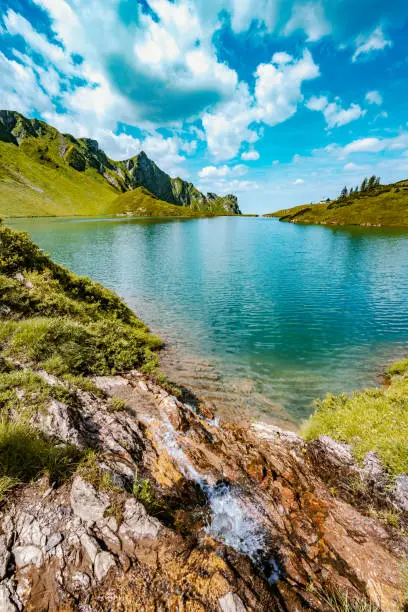 Description: Idyllic turquoise mountain lake in the afternoon. Schrecksee, Hinterstein, Allgäu High Alps, Bavaria, Germany.