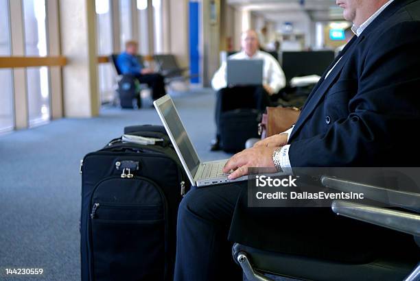 Business Man Working On Lap Top At Gate In Airport Stock Photo - Download Image Now - Adult, Airport, Airport Departure Area