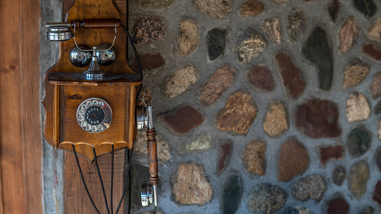 Vintage telephone hanging on the brick wall stock photo