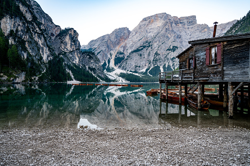 Description: Panoramic view of Braies Lake with the hut and boats in Dolomites mountains and Seekofel in the morning. Braies Lake (Pragser Wildsee, Lago di Braies), Dolomites, South Tirol, Italy, Europe.