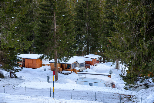 View of a campground in a snowy forest in the European Alps in winter