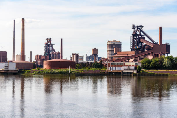 istock Steel plant along a river on a cloudy summer day 1442307190