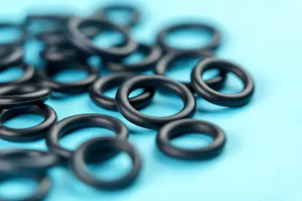 Photo of Black elastic rubber o-rings with a round geometric shape