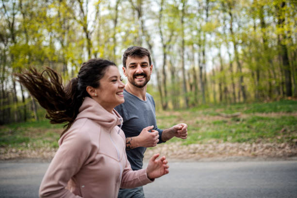 istock Happy athletic couple having fun while running in spring day 1442307998