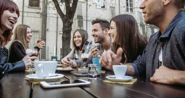 istock People tasting hot drinks at coffee restaurant  - Millennial friends talking and having fun together at sidewalk cafe - Life style concept with happy men and women at bar cafeteria 1442308384