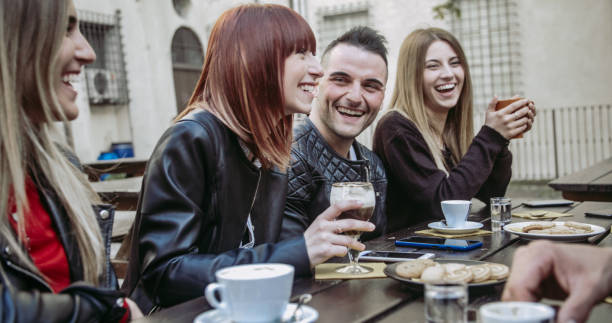 istock People tasting hot drinks at coffee restaurant  - Millennial friends talking and having fun together at sidewalk cafe - Life style concept with happy men and women at bar cafeteria 1442308411