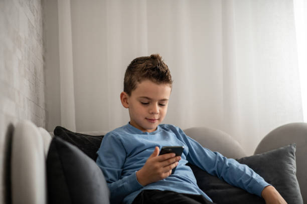 istock Young boy using his parents smart phone 1442309649