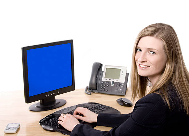 Woman working at her desk smiling at you
