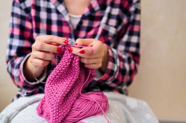 istock femele learning knitting on needles. Hobby knitting and needlework 1442311312