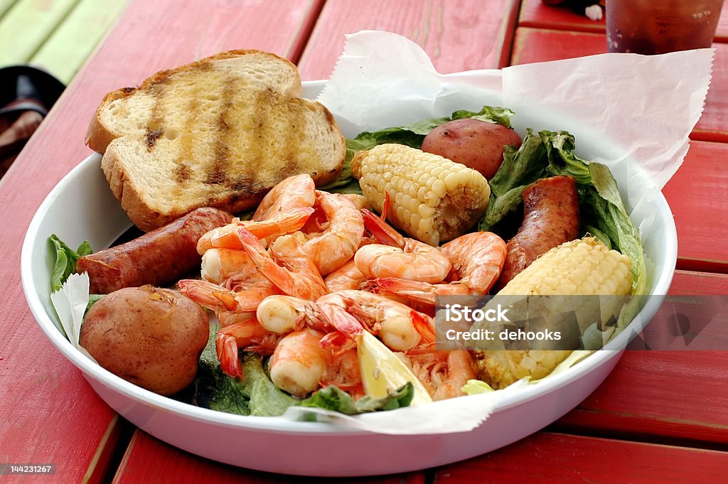 Shrimp Boil Shrimp boil with corn, sausage, potatoes, and bread. Bread Stock Photo