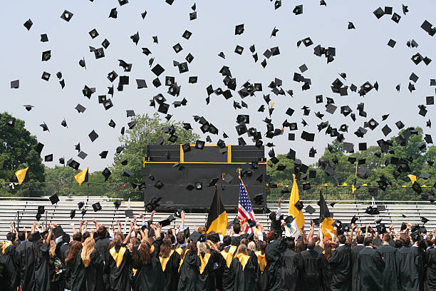 caps in the air Graduation day photo with absolutely no recognizable faces mortarboard photos stock pictures, royalty-free photos & images