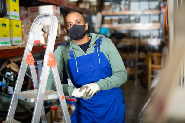 istock Workman in protective mask standing among shelving in construction hypermarket 1442316687