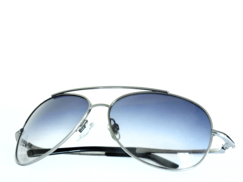 Aviator/Retro style sunglasses with folded arms on a white background