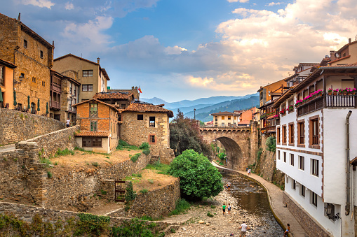 Medieval village of Potes with hanging houses and Deva river, Cantabria, Spain.
