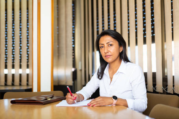 istock Positive latin american woman signing documents 1442317663