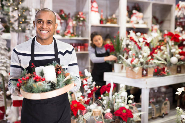 istock Flower shop owner holding christmas composition 1442317783