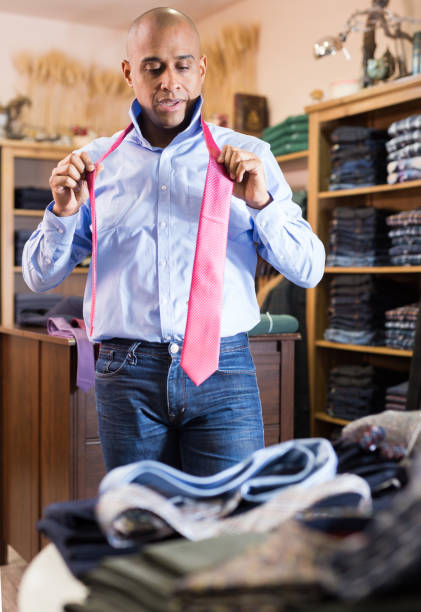 istock Man choosing new tie in clothing boutique 1442317831
