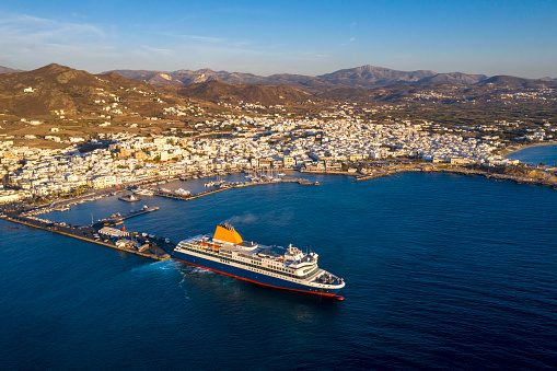 Ferry leaving Naxos harbour in the Aegean Sea, aerial view, Cyclades, Greece.