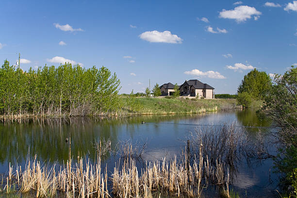 istock House with small pond in Alberta 144231927