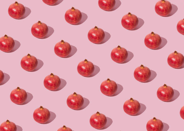istock Summer fruit pattern concept made of pomegranate on pastel pink background. 1442319612