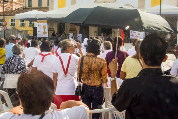 people are standing in front of the church waiting for the celebration of corpus christ day - confessional nun catholic imagens e fotografias de stock
