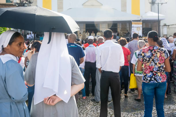 nuns and catholics are attending the corpus christ day mass - confessional nun catholic imagens e fotografias de stock