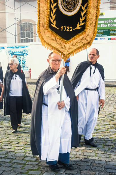 catholic faithful walk the streets of pelourinho with banners during the corpus christ day ceremony - confessional nun catholic imagens e fotografias de stock