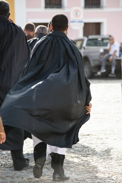 catholics walk, dressed in black clothes, during the corpus christ mass - confessional nun catholic imagens e fotografias de stock