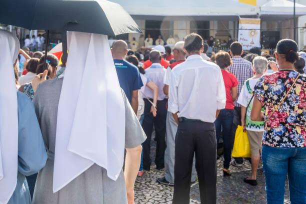 nuns and catholics are attending the corpus christ day mass - confessional nun imagens e fotografias de stock