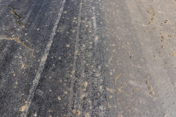 istock Details of a road polluted with sand and debris from fields 1442321428