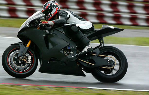 Superbiker A Superbiker Racing On A Race Track motorcycle racing stock pictures, royalty-free photos & images