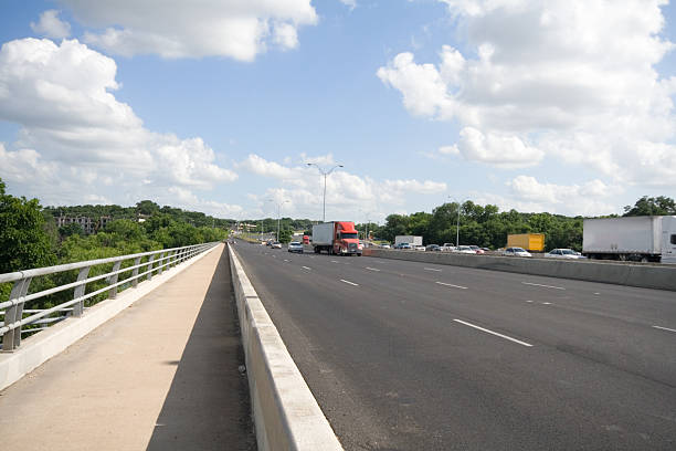 istock Interstate Highway Bridge Truck Traffic Blue Sky 144232205