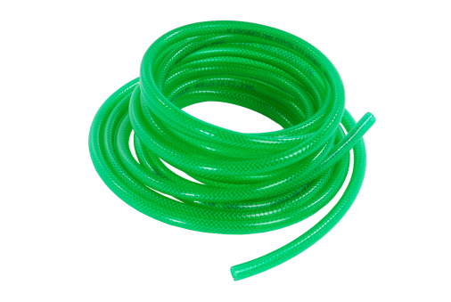 Coiled green garden hose isolated on a white background.