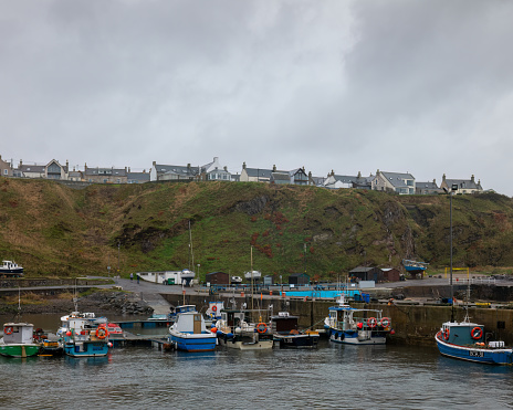 17 November 2022. Portknockie,Moray,Scotland. This is the view across the Harbour to the cliffs and dwelling houses of the small fishing town.