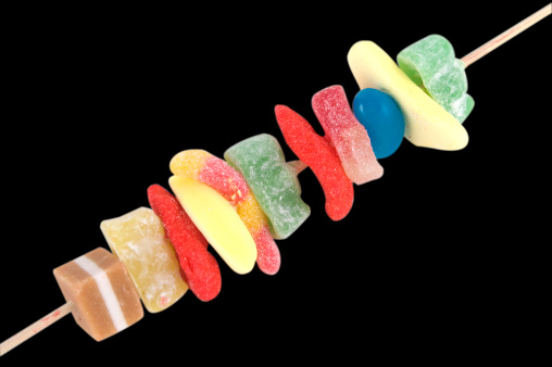 Lots of different candy on a stick isolated on a black background. Has clipping path