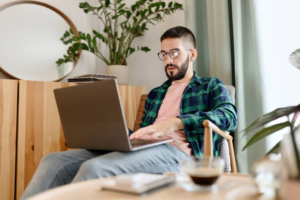 istock Man working on a laptop at home 1442329140