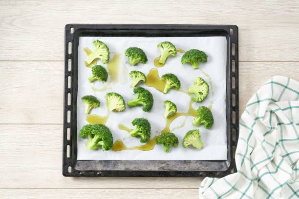 istock broccoli with olive oil and spice on baking tray, preparation for baking, top view. 1442331132