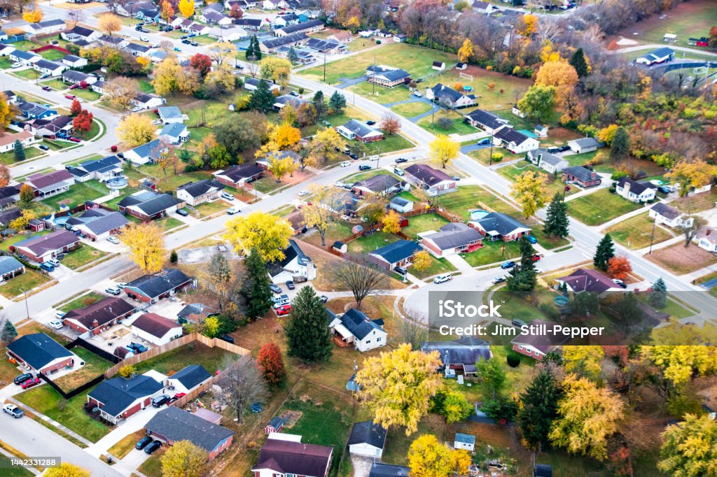 At the End of a Cul-De-Sac:  An Aerial View of a Housing Development in the Autumn A drone view of a subdivision with roads and a cul-de-sac. There are single and two-story housing. The scene features colorful autumn trees. Ohio Stock Photo