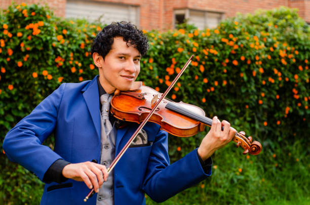 istock Man playing the violin outside with copy space 1442332068