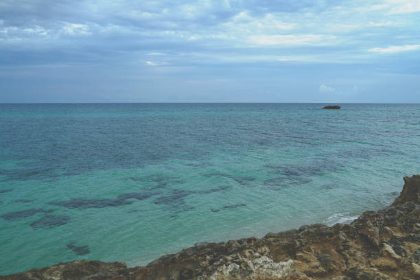 Thunderstorm coming from the horizon with a calm and crystalline sea