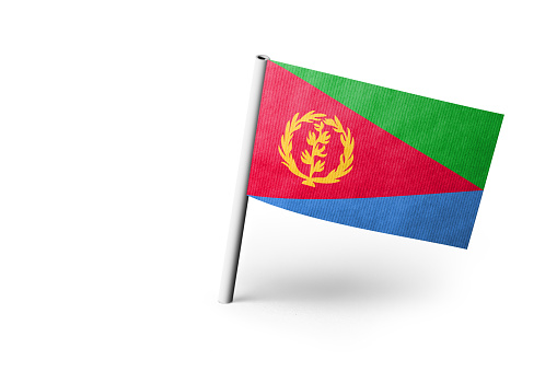 Small paper flag of Eritrea pinned. Isolated on white background. Horizontal orientation. Close up photography. Copy space.