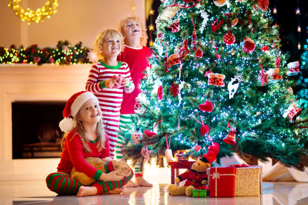 istock Child decorating Christmas tree. Kid on Xmas eve. 1442334847