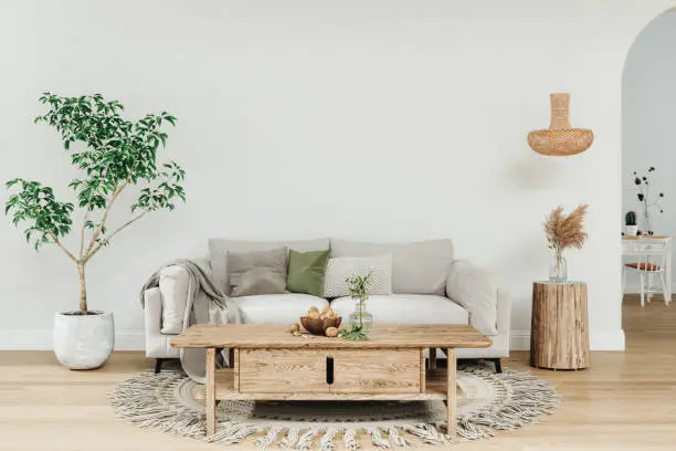 Interior of a cozy living room with wooden furniture and pastel colors.