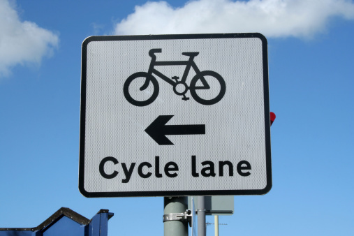 Cycle lane sign against a bright blue sky