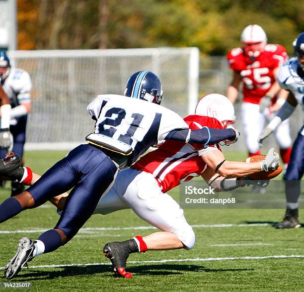 College Football Catch And Tackle Stock Photo - Download Image Now - American Football - Sport, American Football - Ball, Tackling