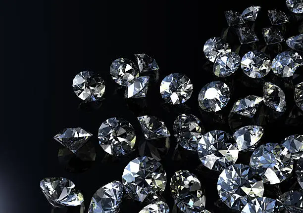 Photo of Loose diamonds scattered on black background